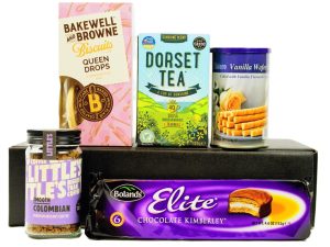 The Tea, Coffee and Biscuits Gift Box beholds a delightful selection of sweet treats to accompany the Dorset Tea sunshine blend tea and Little's Colombian rich instant coffee. Bolands chocolate Kimberley's, Bolero vanilla wafers and the fabulously fruity Bakewell and Browne Queen drops. Presented within a black lidded box and finished with a hand tied red satin bow.